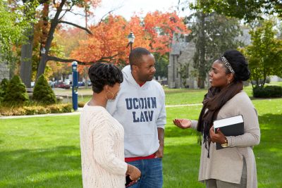 Uconn Law students speaking to each other on campus